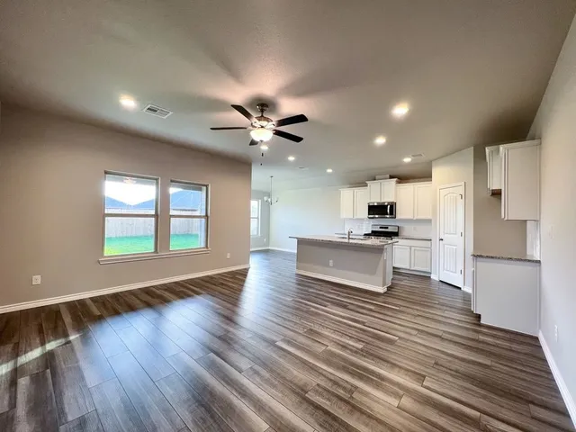 a view of kitchen with closet and windows