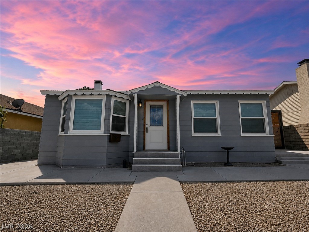 This charming home presents an inviting facade under a vibrant sky, offering comfort and style.