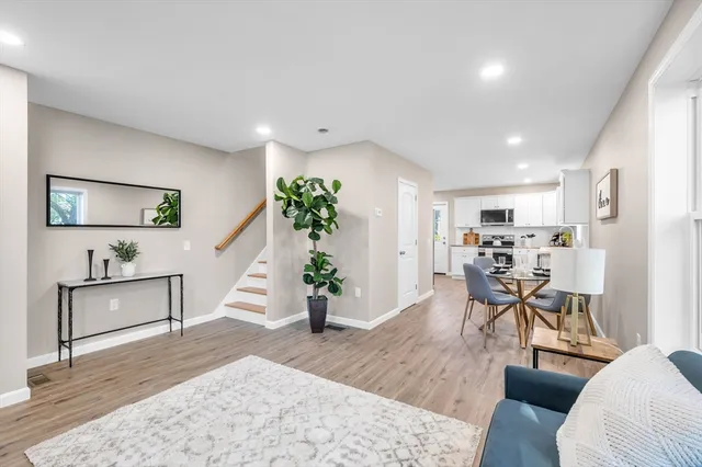 a living room with furniture and a potted plant