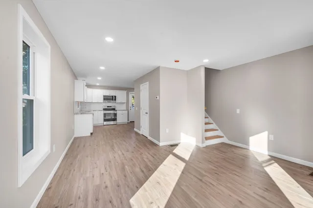 a view of a kitchen with wooden floor and a kitchen