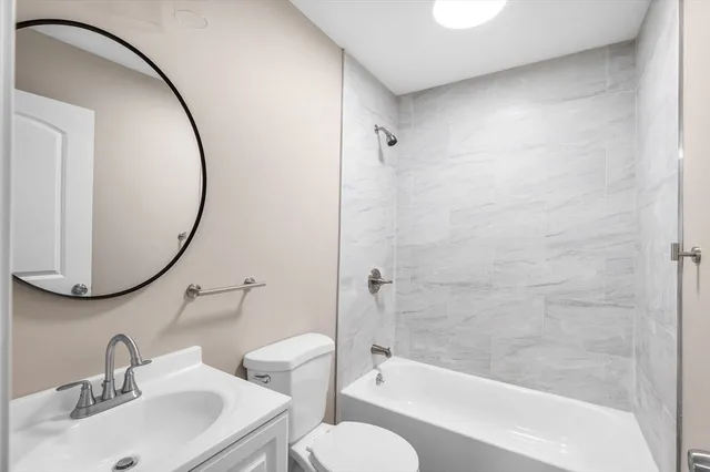 a bathroom with a sink a toilet and a mirror