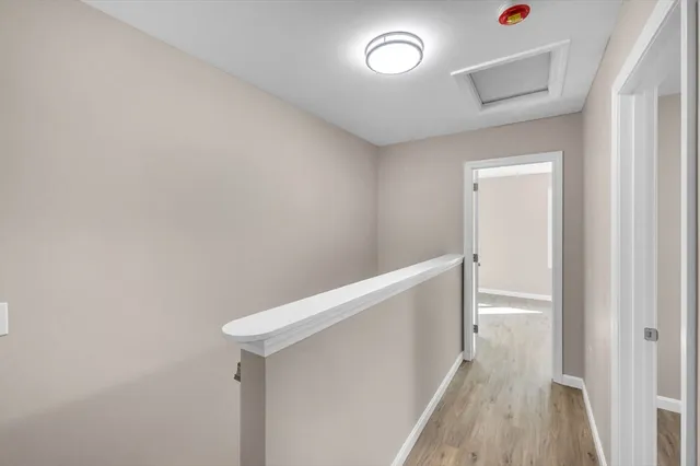 a view of hallway with wooden floor