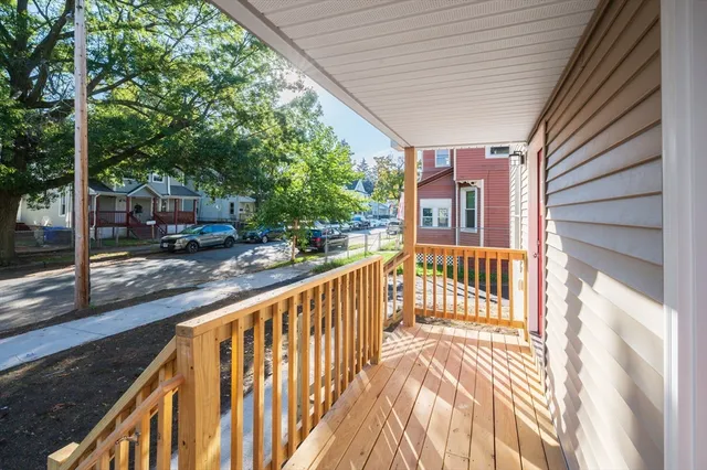a view of a porch with wooden floor and fence