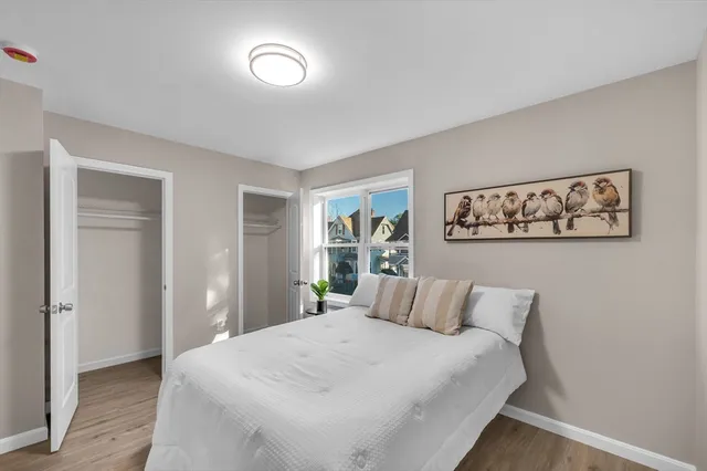 a bedroom with a large bed and a window