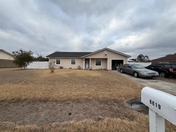 a front view of a house with cars parked