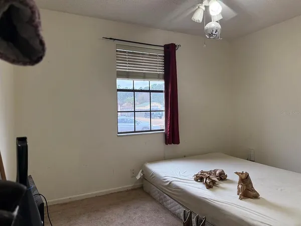 a bedroom with a bed and a chair