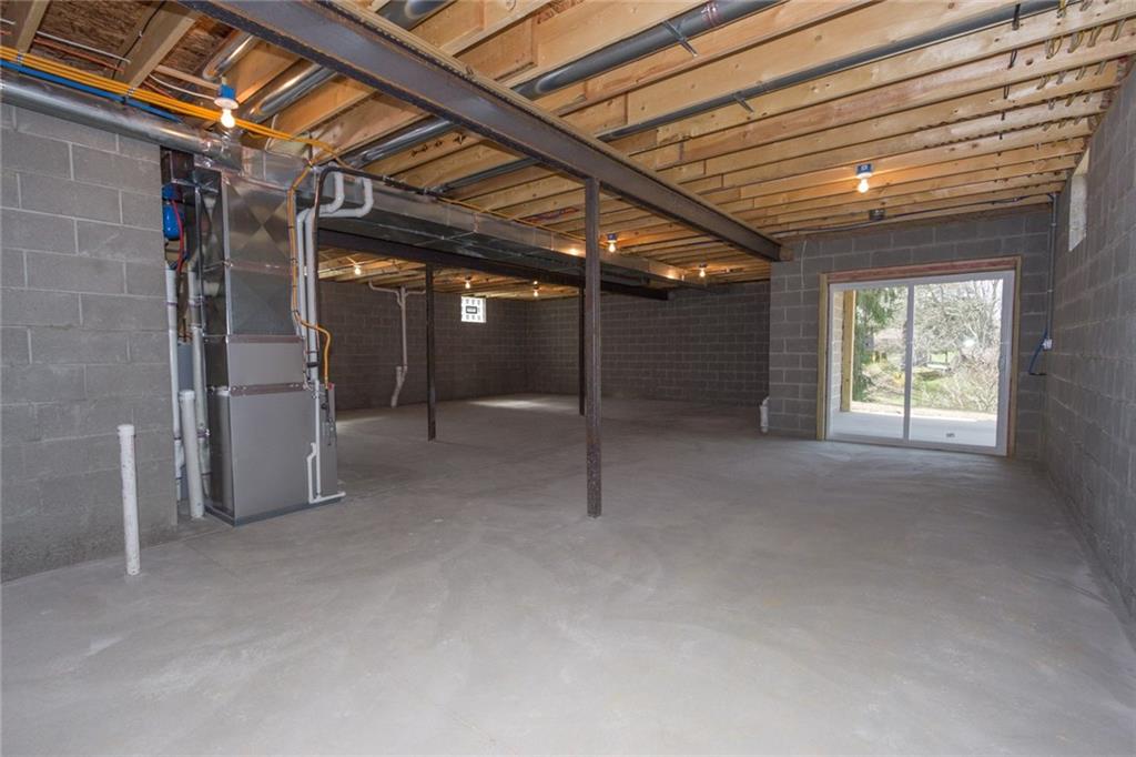 155 Spring Hill Road Aliquippa, PA 15001 - Photo 15 of 18 HUGE basement with high ceilings, plumbed for a bathroom, and a walk out to a cement patio.