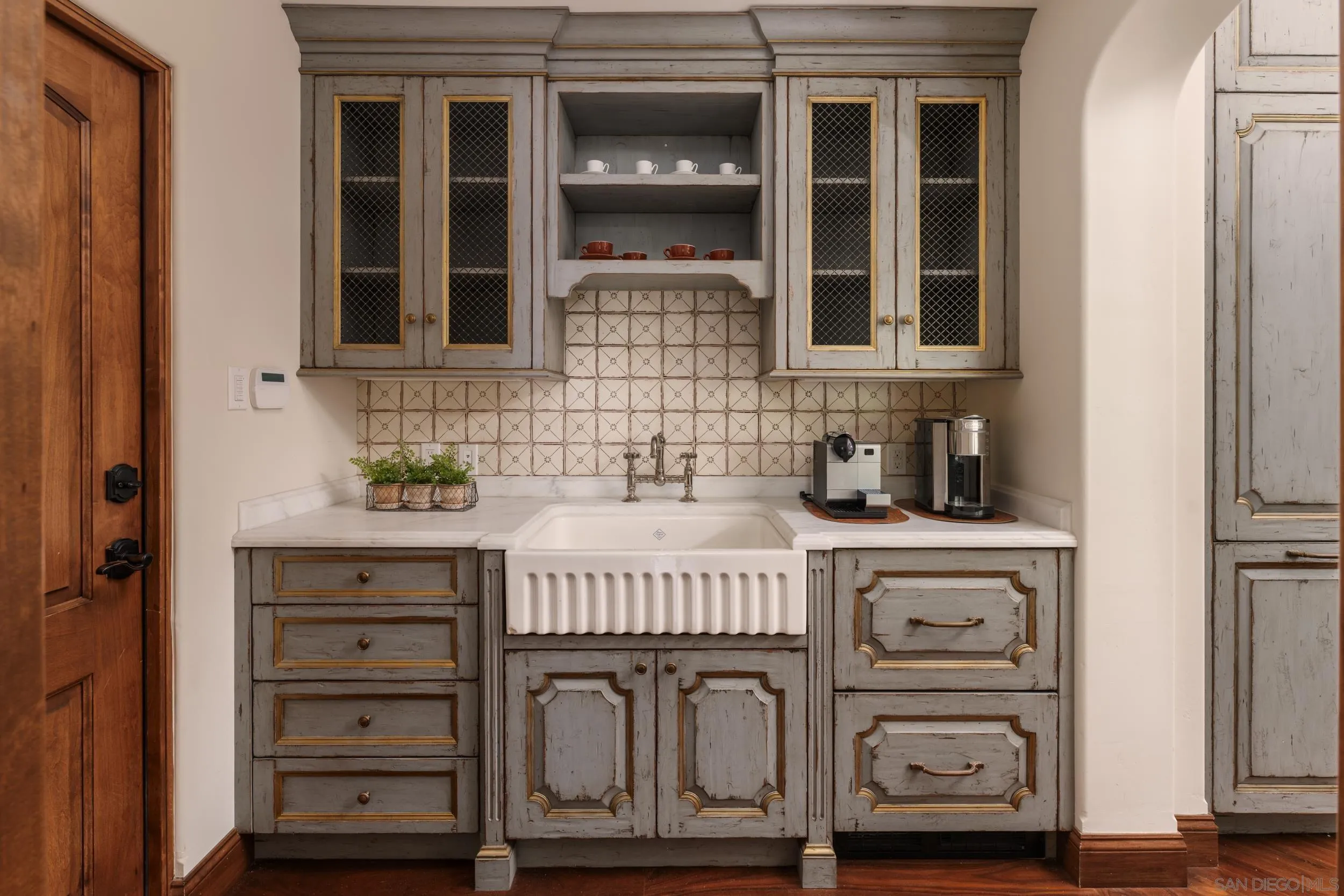 5406 Calzada Del Bosque Rancho Santa Fe, CA 92067 - Photo 17 of 30 a kitchen with a sink and cabinets