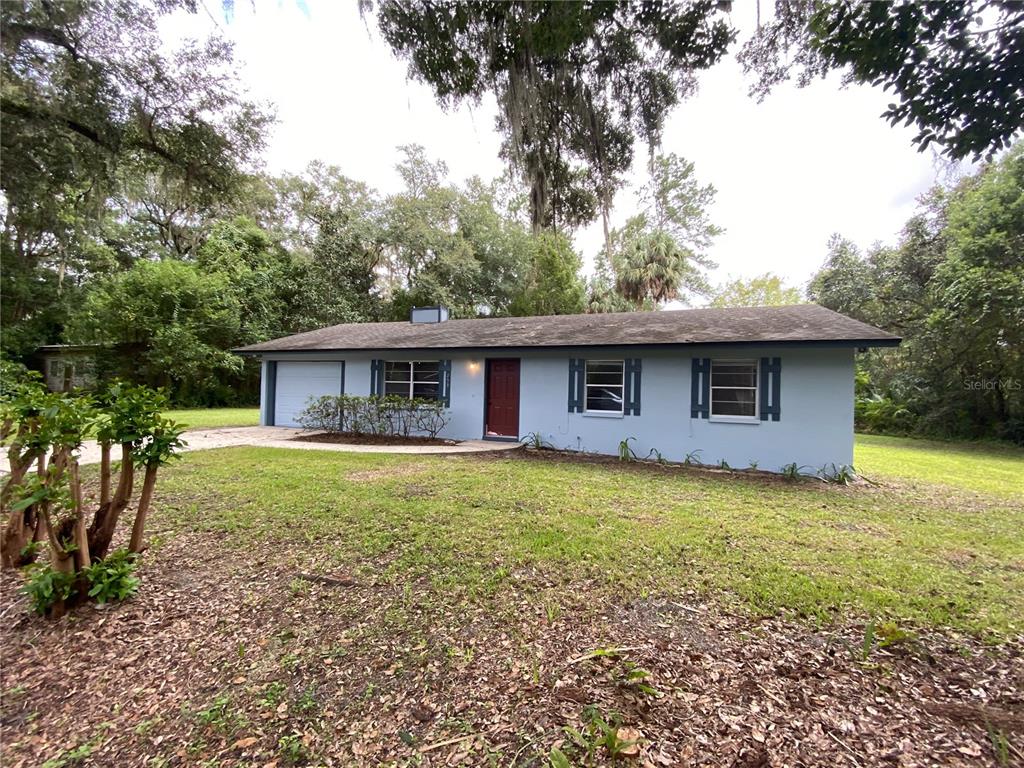 253 Northwest 3rd Street Micanopy, FL 32667 - Photo 1 of 22 a front view of a house with garden