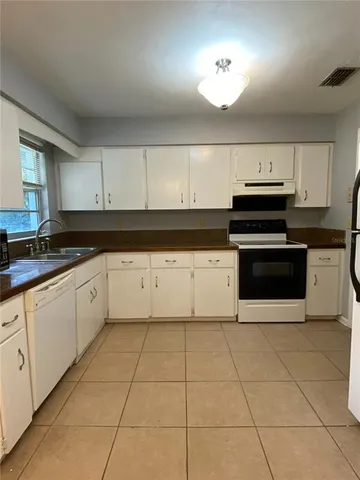 a kitchen with cabinets and appliances