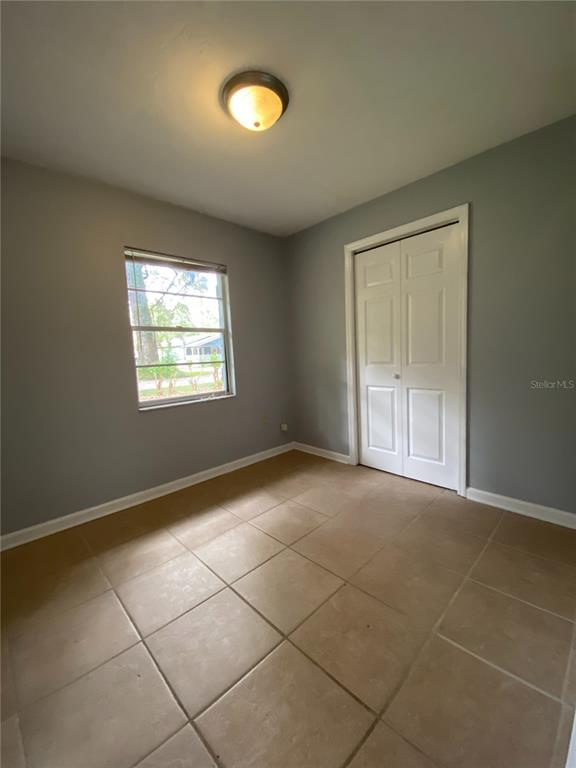 253 Northwest 3rd Street Micanopy, FL 32667 - Photo 8 of 22 an empty room with windows