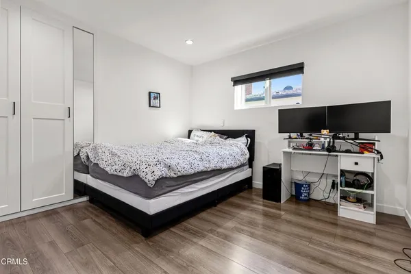 a bedroom with a bed and a flat screen tv