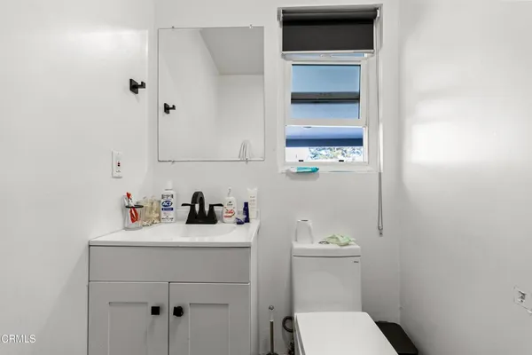a bathroom with a sink a toilet and vanity