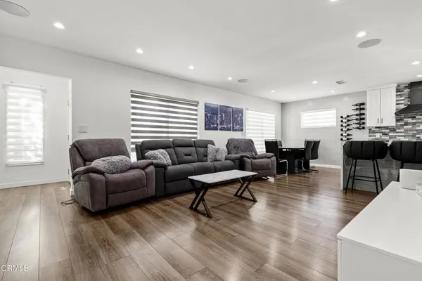 a living room with furniture and wooden floor