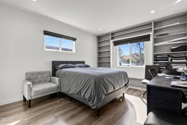 a spacious bedroom with a bed and a window