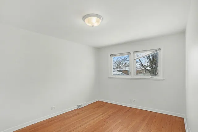 an empty room with a painting on the wall