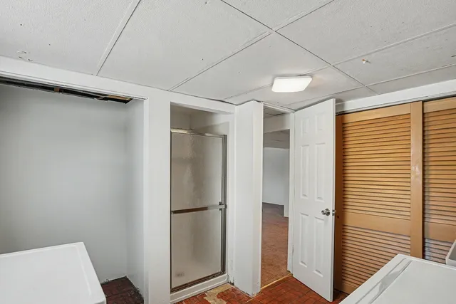 a view of a livingroom with an empty space and a hallway