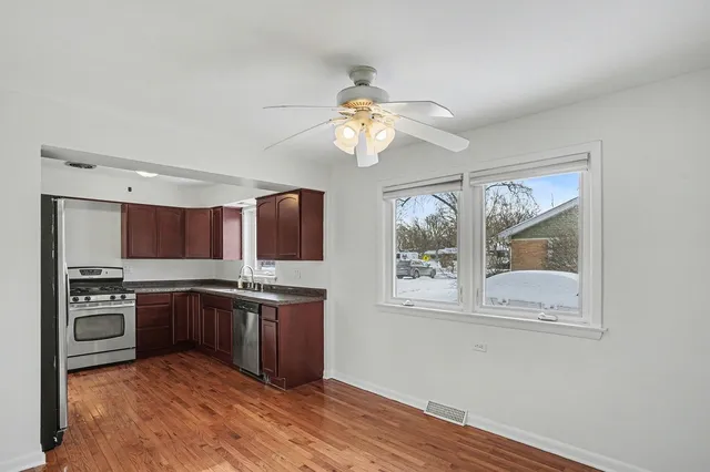 a kitchen with stainless steel appliances granite countertop a stove and cabinets
