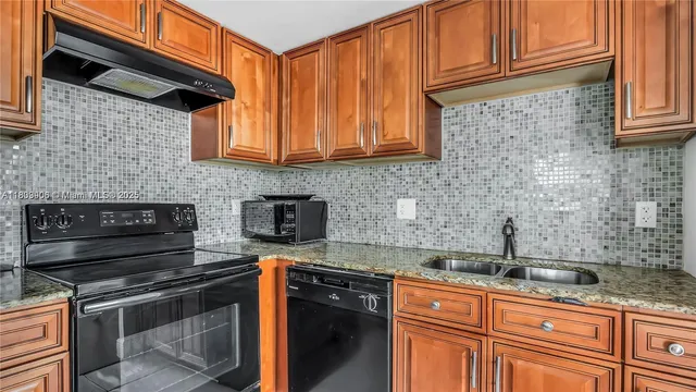 a kitchen with stainless steel appliances granite countertop a sink stove and cabinets