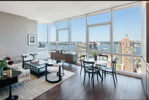 a dining room with furniture window and wooden floor