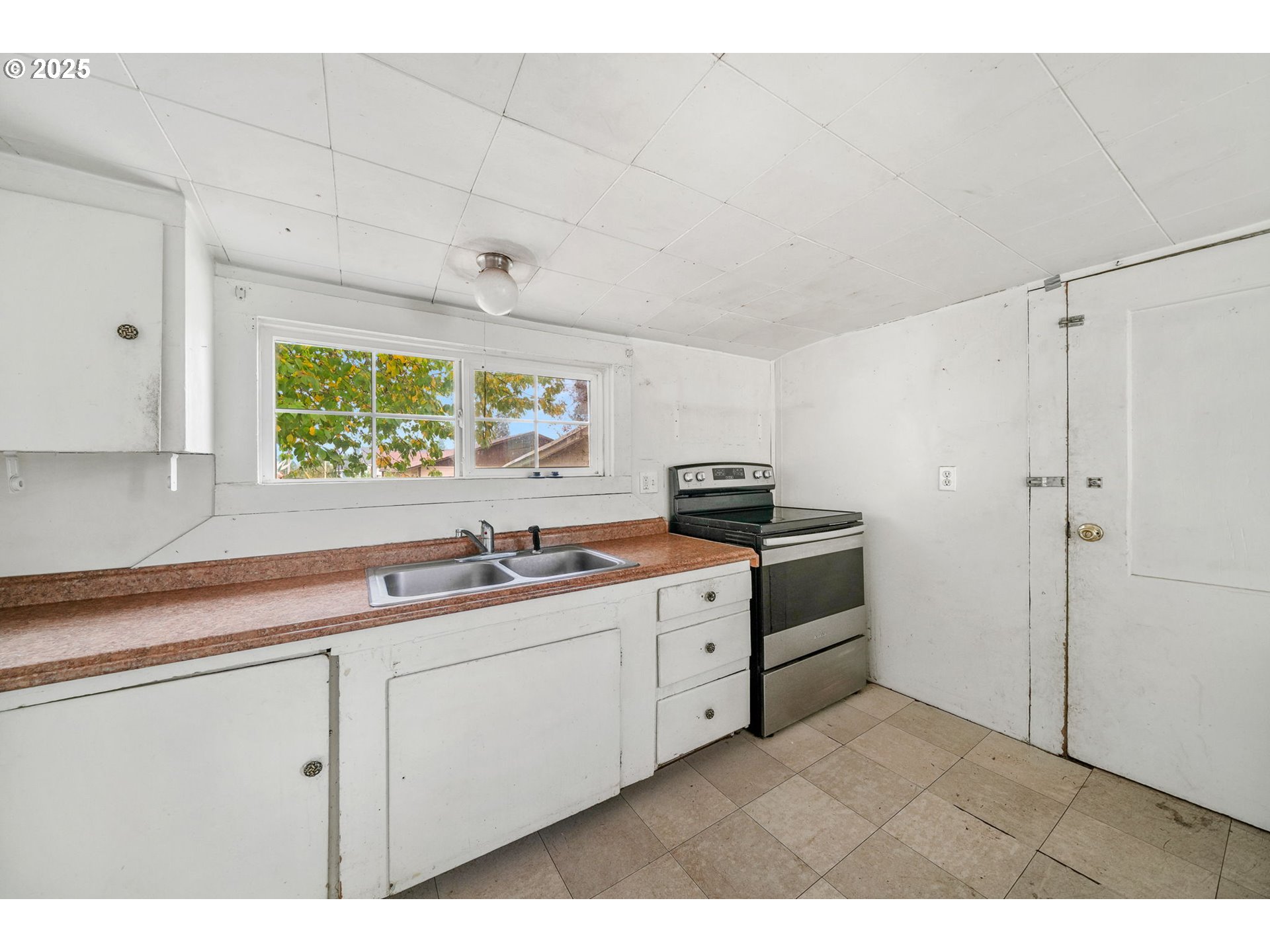 810 Johnson Avenue Cottage Grove, OR 97424 - Photo 8 of 17 a kitchen with stainless steel appliances a sink cabinets and a window
