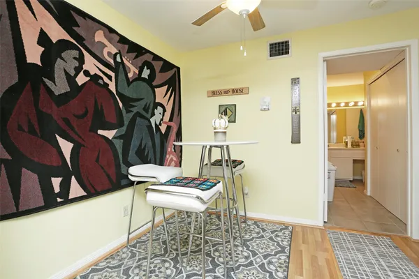 a very nice looking room with many windows and wooden floor