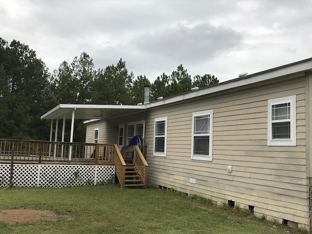 4036 Poverty Creek Road Crestview, FL 32539 - Photo 16 of 24 a front view of a house with a garden