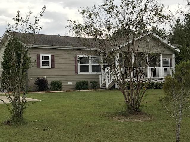 4036 Poverty Creek Road Crestview, FL 32539 - Photo 2 of 24 a front view of a house with a yard