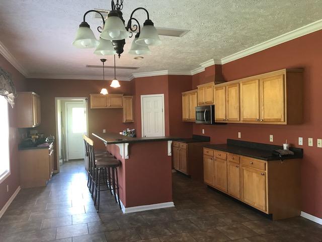 4036 Poverty Creek Road Crestview, FL 32539 - Photo 3 of 24 a kitchen with stainless steel appliances kitchen island granite countertop a stove a sink and a refrigerator