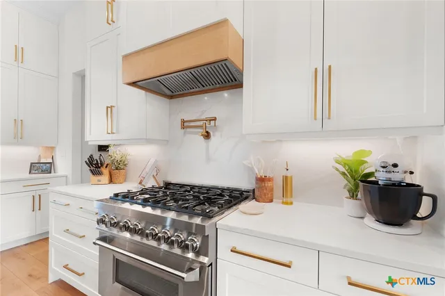a kitchen with a stove and cabinets