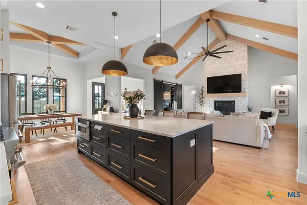 a large kitchen with a table and chairs in it