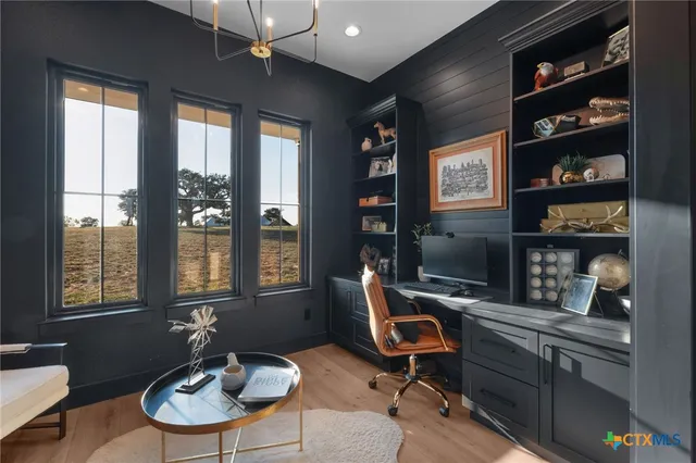 a work room with furniture potted plant and a window