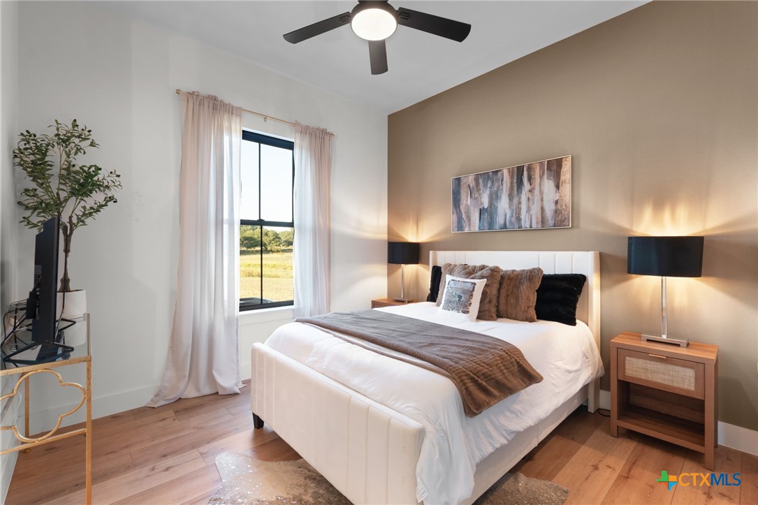 871 Blackbuck Ridge Drive Lampasas, TX 76550 - Photo 18 of 48 a bedroom with a bed and a chandelier