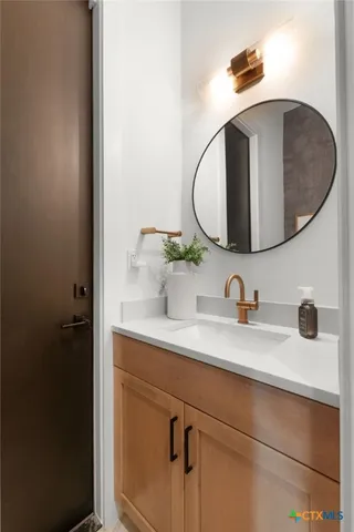 a bathroom with a sink and mirror