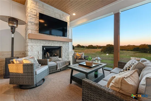 a living room with furniture fireplace and flat screen tv