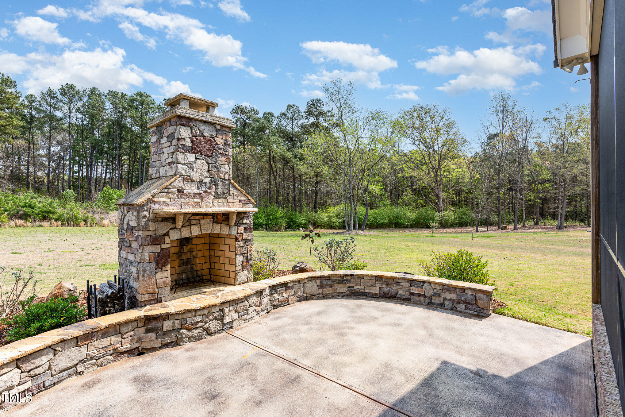 1505 Sweetwater Lane Raleigh, NC 27610 - Photo 45 of 54 Lovely Patio w/Stone Masonary Fireplace to Enjoy Cool Evenings Overlooking your 1 acre Lot.