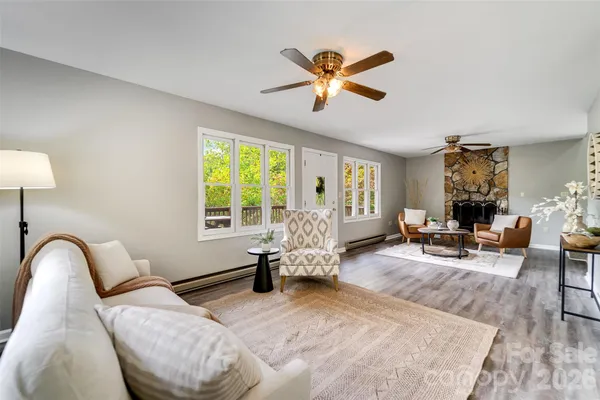 a living room with furniture and wooden floor