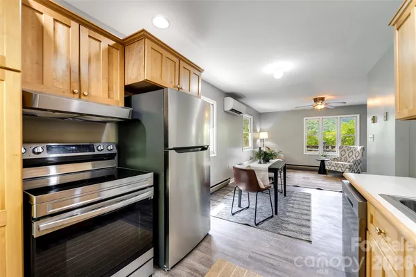 a kitchen with sink refrigerator and dining table