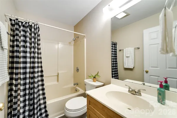 a bathroom with a sink a toilet a shower and a mirror