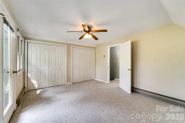 a view of empty room with ceiling fan