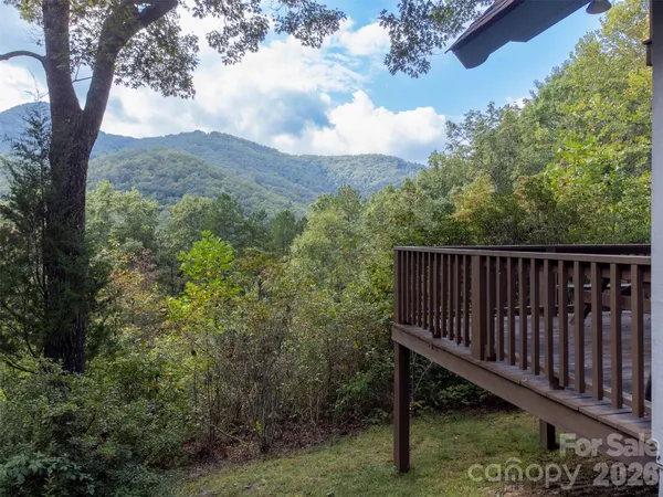 a view of a roof deck with wooden fence and floor
