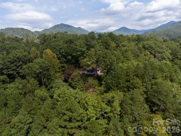 an aerial view of a house with mountain view