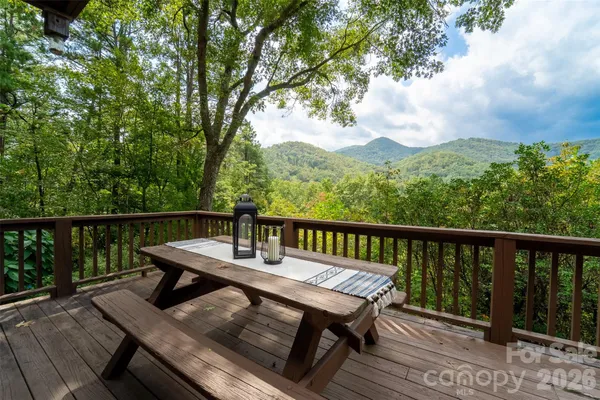 a view of a balcony with wooden floor and outdoor seating