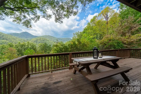 a view of a balcony with wooden floor and outdoor seating
