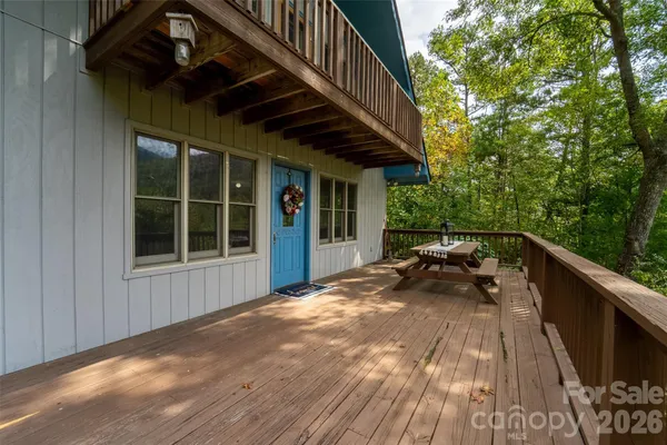 a view of backyard with deck and outdoor seating
