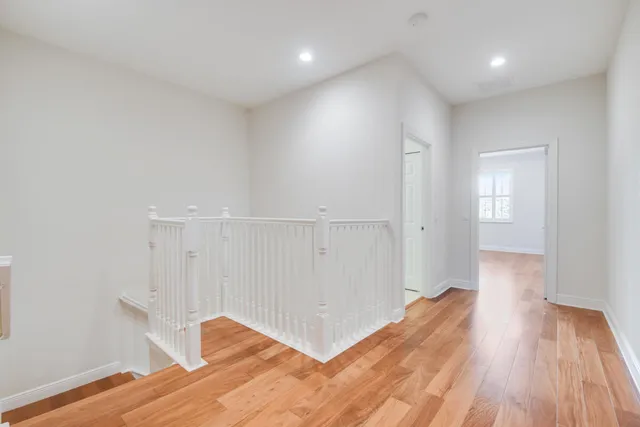 a view of hallway with wooden floor