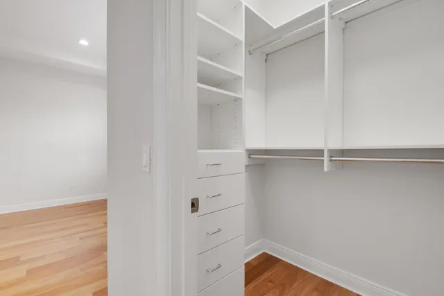 a view of walk in closet with empty racks