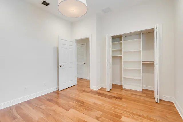 a view of a room with wooden floor and closet