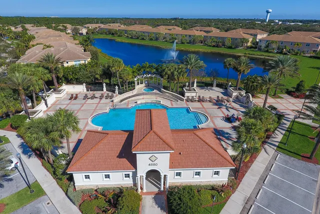 an aerial view of house with yard swimming pool and outdoor seating
