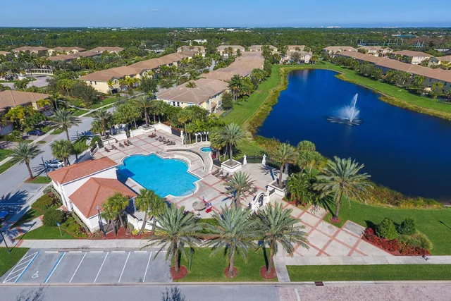 an aerial view of residential houses with outdoor space and swimming pool
